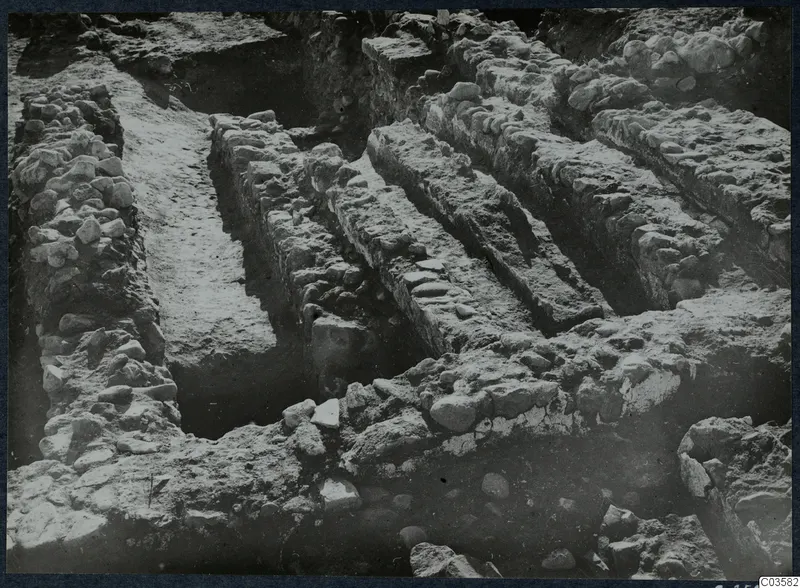 Excavated stone walls and foundations at Soli, Cholades Temples C-F, running diagonally across a trench