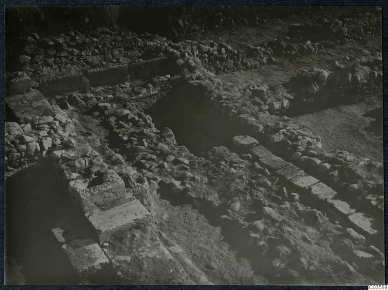 Excavated stone walls and rubble at Soli, Cholades Temples, with dressed stone blocks in a line.
