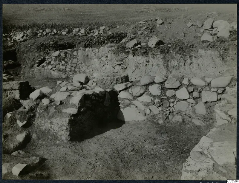 Excavated stone walls and rubble at the Cholades Temples A-B at Soli, seen from a trench.