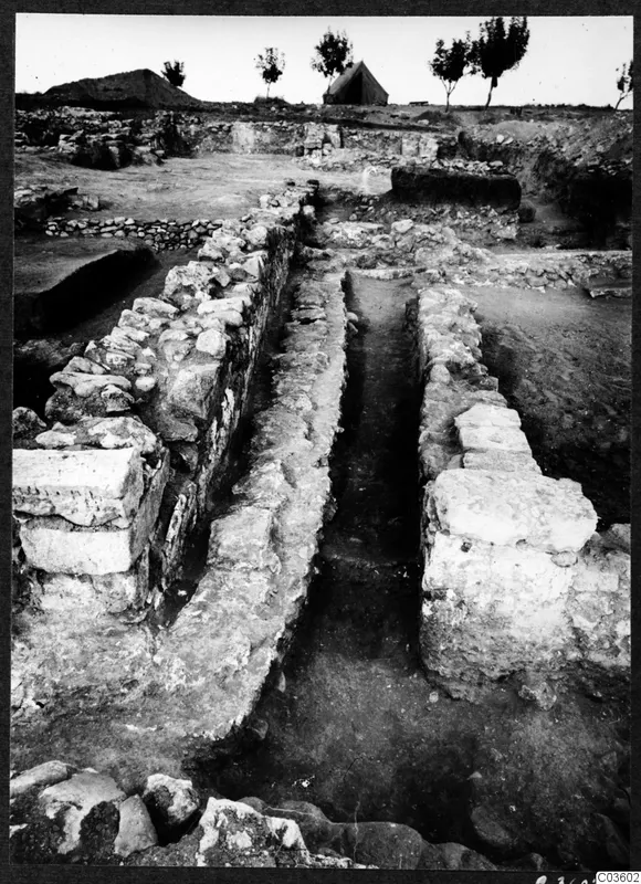 Excavated stone foundations of Temples A-B at Cholades, Soli, with a narrow trench between walls