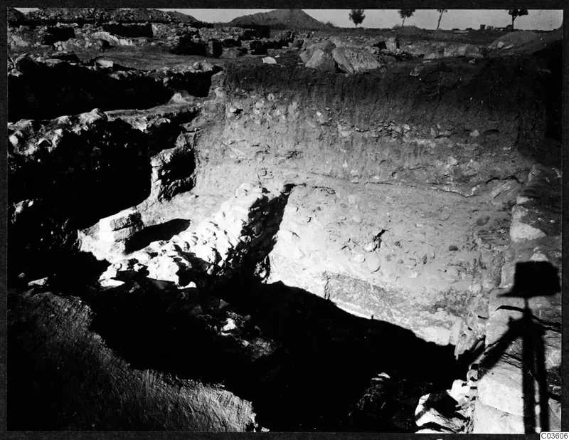 Excavation trench at the Cholades temples A-B at Soli, with exposed stone walling and a layered soil section