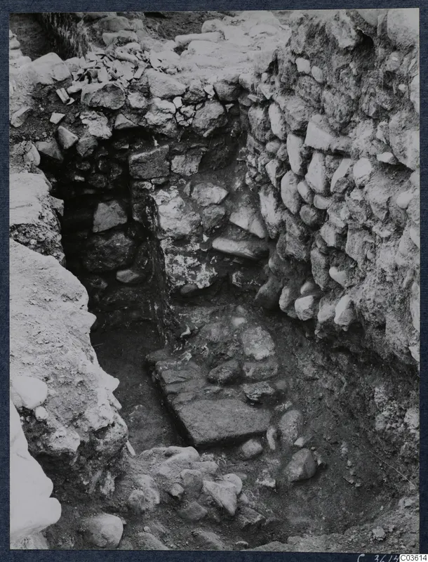 Excavation trench at Soli with rubble stone walls and a flat stone slab on the floor, Cholades temples area.