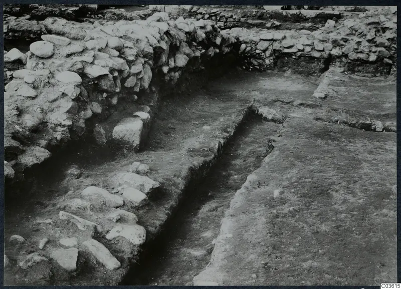 Excavated stone walls and a paved surface at Soli, Cholades temples