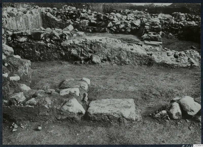 Excavated stone walls and foundations at Soli, Cholades Temples A-B, with a large flat stone block in the foreground.