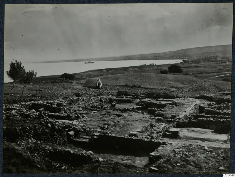 Excavation at Cholades, Soli, Temples A-B, with wall foundations, a tent and a boat on the water