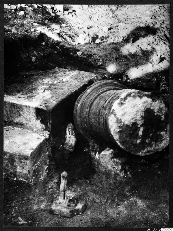 Finds in situ during excavation at Cholades, Soli: a stone step, a fluted column drum and small carved objects in the soil.