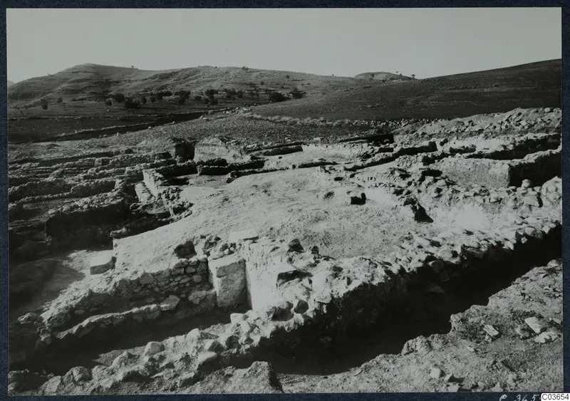 Excavated stone walls of Temples A-B at Soli, Cholades, on a hillside with hills behind