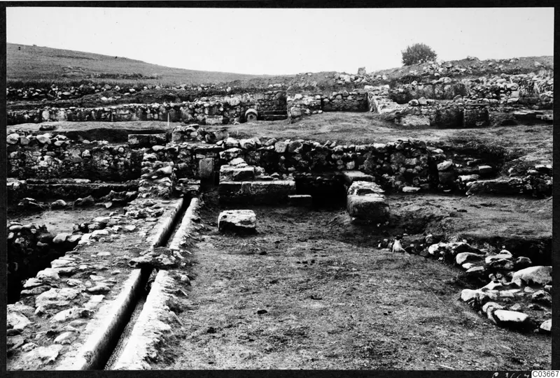 Excavated stone walls and a stone-lined channel at the Cholades temples A-B at Soli
