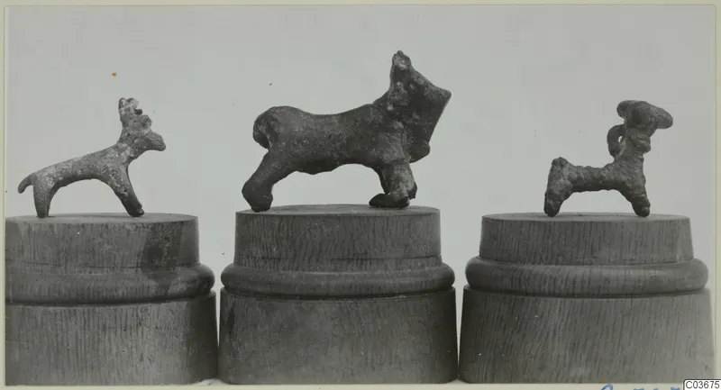 Three small bronze figurines of animals on wooden stands