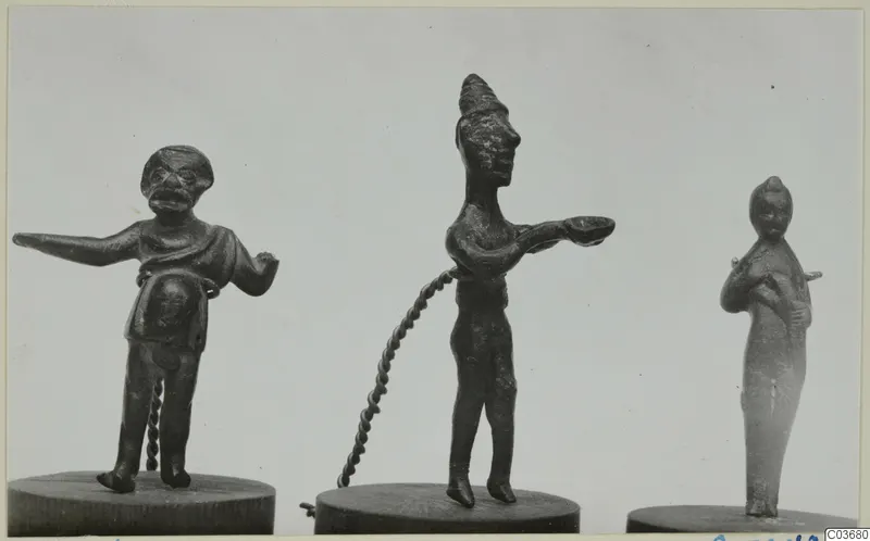 Three small bronze figurines standing on round wooden bases.