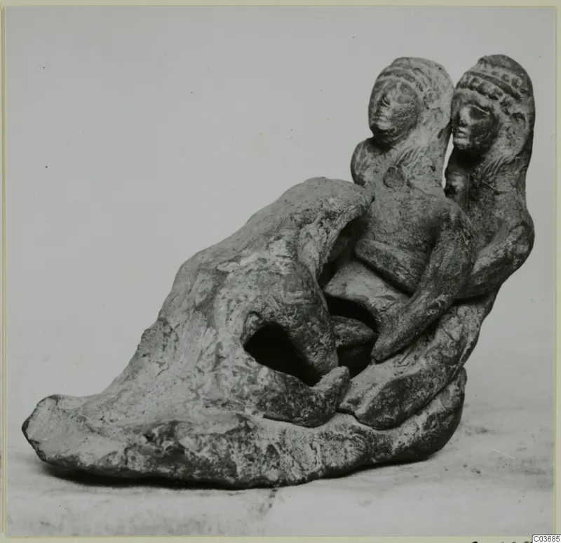 Terracotta figurine group of two heads and bodies joined to a rounded base with an opening