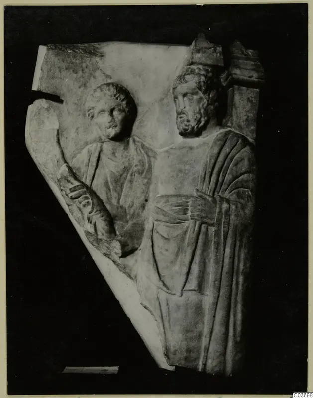 Relief fragment of two standing figures carved in pale stone, one of them bearded