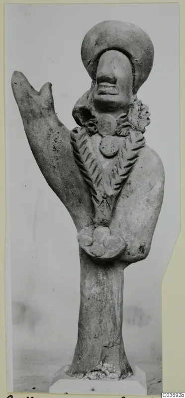 Terracotta figurine with a large rounded head, an incised pattern across the chest and a raised projection on one side