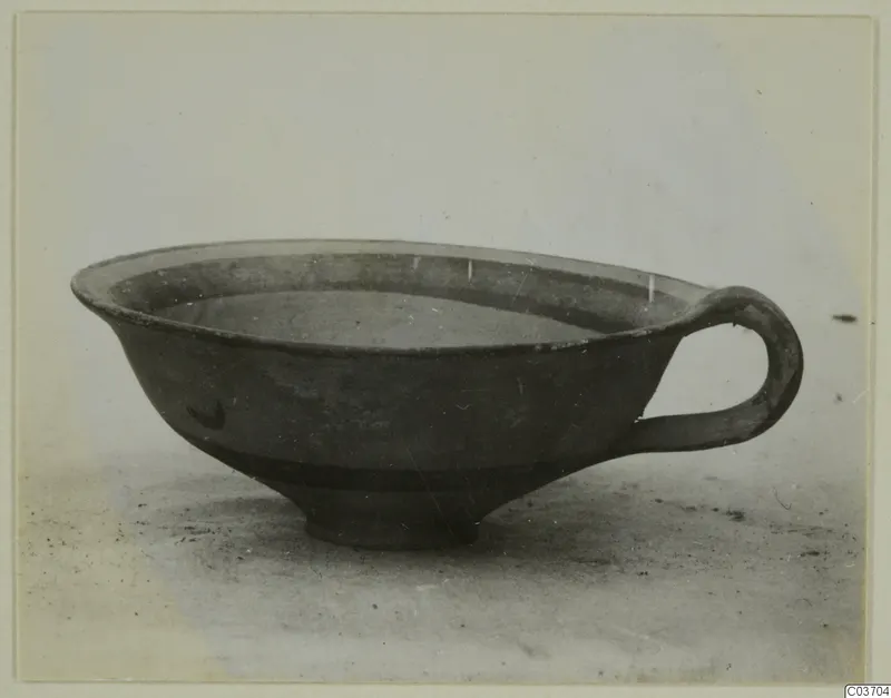 Pottery Levanto-Helladic Ware Bowl-Jar, a dark shallow bowl with a single loop handle, seen from the side