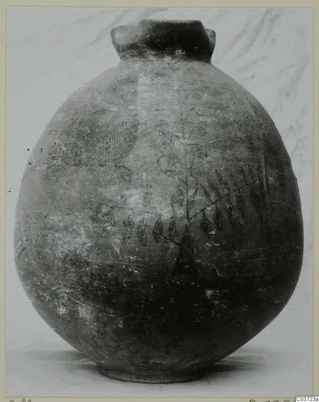 Round jug with a wide flared neck and a painted pattern of leaves, stems and hatched panels on its body