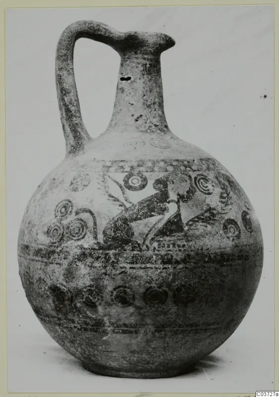 Bichrome IV plate-jug with a globular body, high strap handle and painted bands and concentric circles