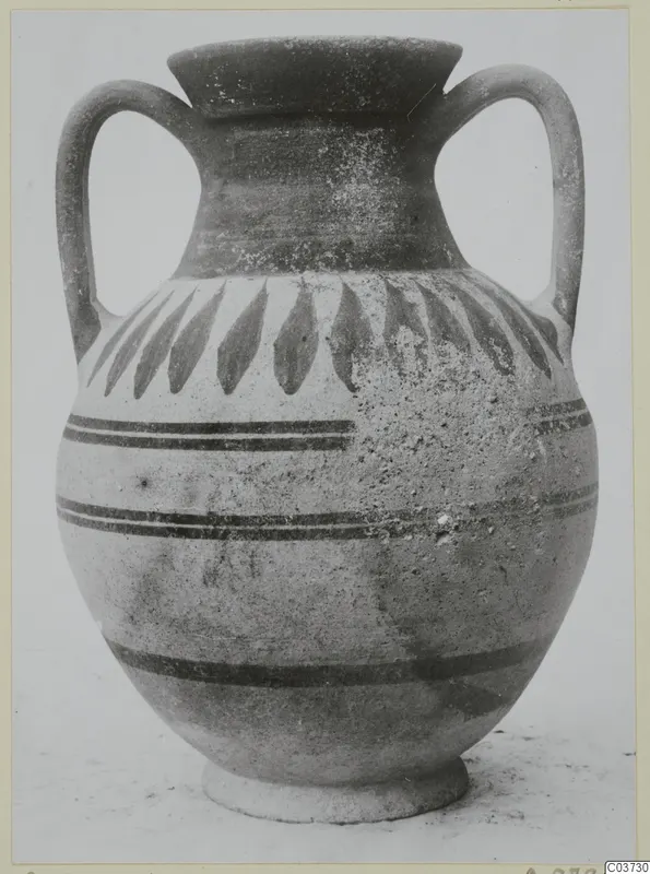 Two-handled jar with painted leaf motifs and horizontal bands, photographed against a plain background.