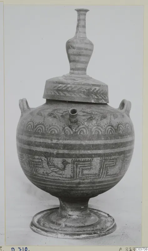 Painted pottery vessel with a rounded body, pedestal foot, two loop handles, a spout and a tall banded neck with a lid