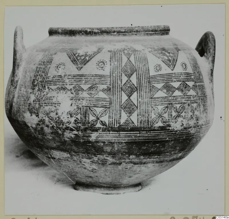 Two-handled painted pottery vessel with hatched geometric decoration, photographed against a light background