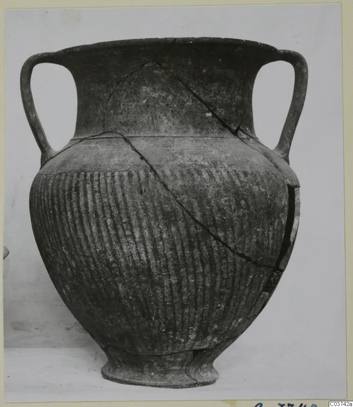 Two-handled pottery jar with vertical ribbing on the lower body, cracked and mended