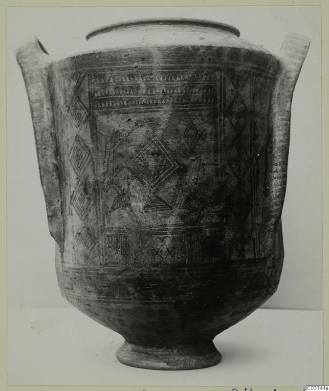 Pottery White Painted I amphora with two handles and diamond and band decoration, photographed on a plain background.