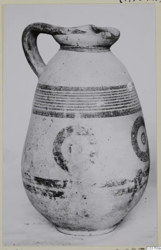 Pottery White Painted IV jug with a loop handle and dark painted bands and circles