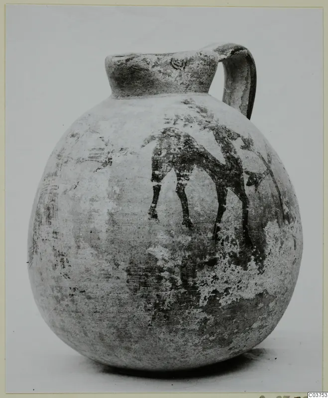 Bichrome IV jug with a strap handle and a painted animal figure on its globular body.