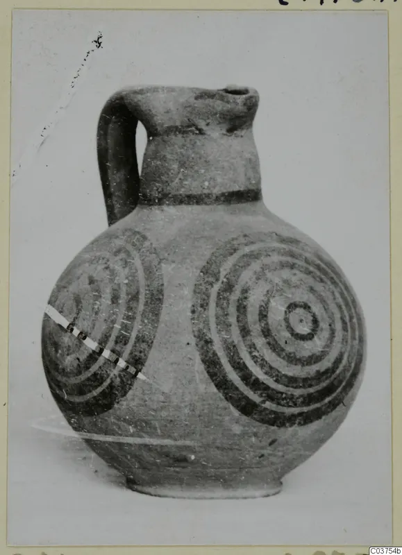 Pottery White Painted IV, a one-handled jug with dark concentric circles painted on its body