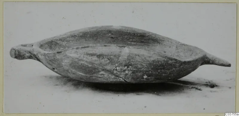 Pottery White Painted III: an elongated, boat-shaped bowl with raised ends, photographed from the side
