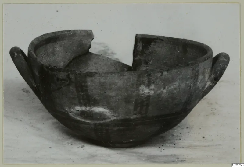 White Painted I bowl with two handles and a broken rim.