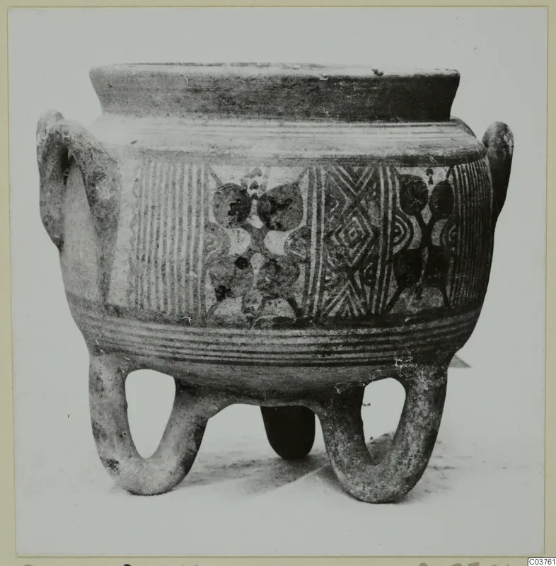 Painted pottery vessel standing on three looped feet, with two side handles and bands of hatched and motif decoration