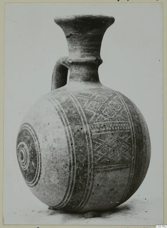 Pottery Bichrome III vessel with a strap handle, painted bands and geometric motifs on its round body