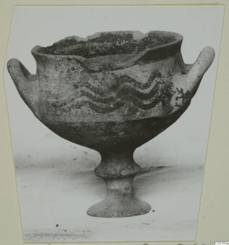 White Painted I bowl on a stem foot, with two side handles and dark wavy painted bands around the body