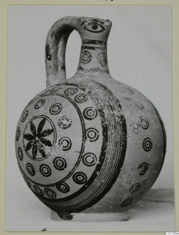 Painted pottery juglet with a strap handle, decorated with concentric circles and a central rosette