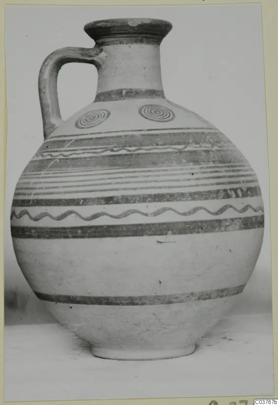Painted jug with banded decoration, wavy lines and two concentric circles on the shoulder