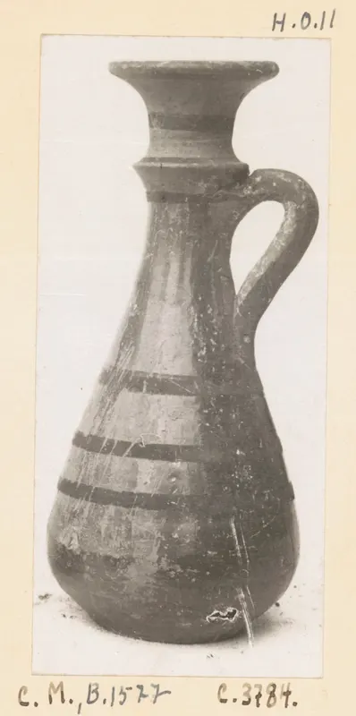 Pottery jug with a flared rim, single loop handle and dark painted bands