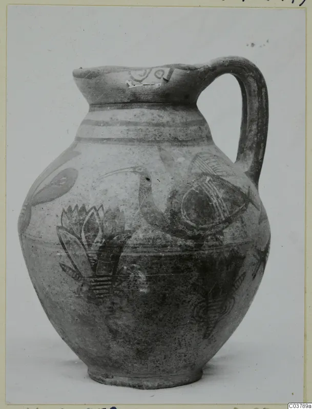Pottery Bichrome IV jug with a painted bird and plant motifs in dark on a pale surface