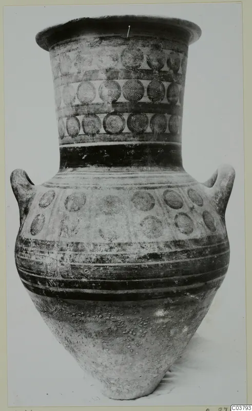 Two-handled jar with a flaring rim, painted with bands of concentric circles and dark horizontal stripes