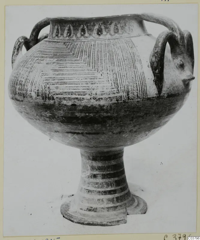 Pottery Bichrome IV vessel with loop handles, a wide body and a tall ring-footed stem, shown on a plain background
