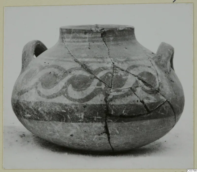 Painted pottery jug with two handles and spiral bands, from the Bichrome series, shown on a plain surface.