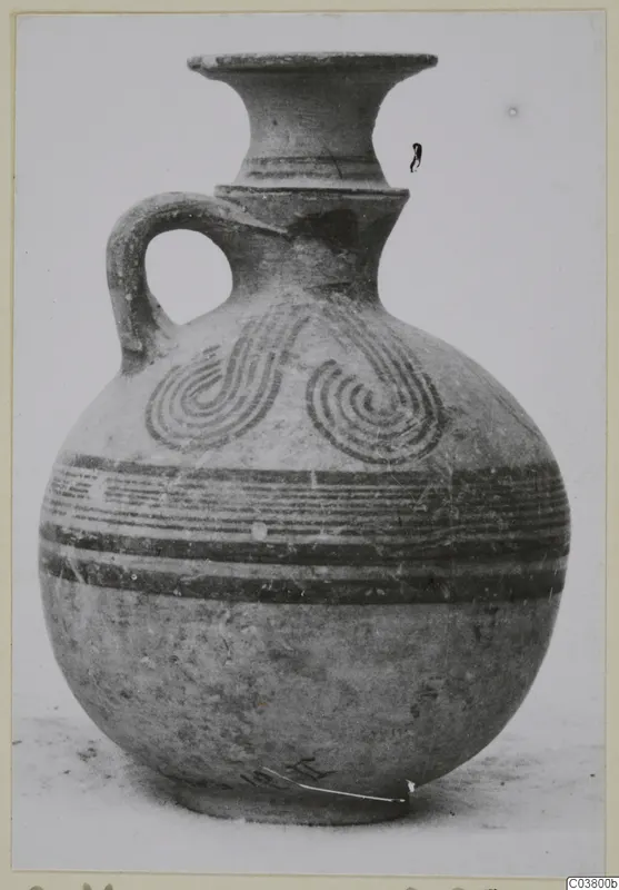 White Painted IV vessel with a flaring neck, single loop handle and painted spiral motifs on the shoulder