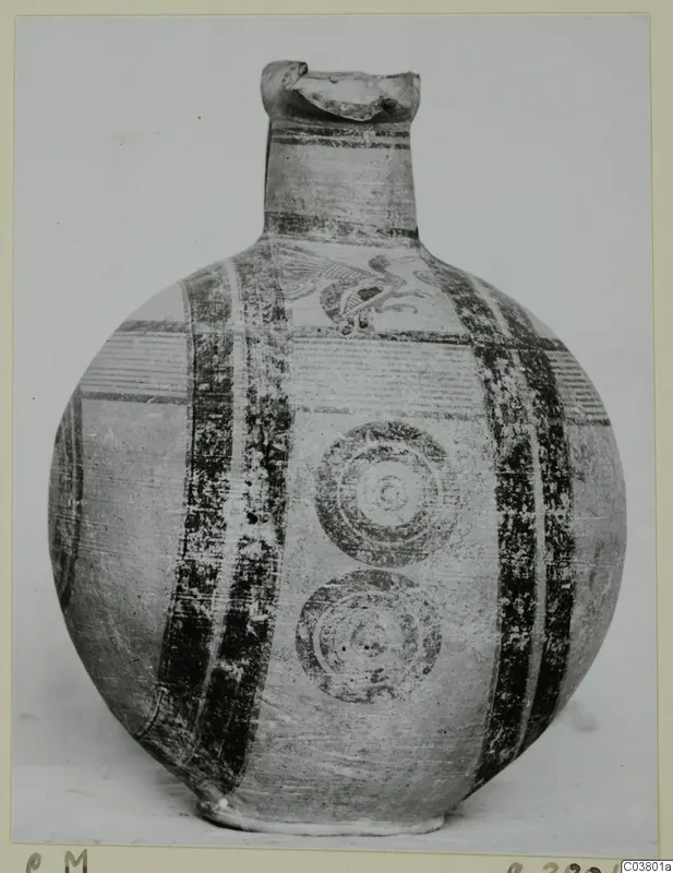 Jug with a round body, a tall neck and dark painted bands, with a bird-like motif on the upper body