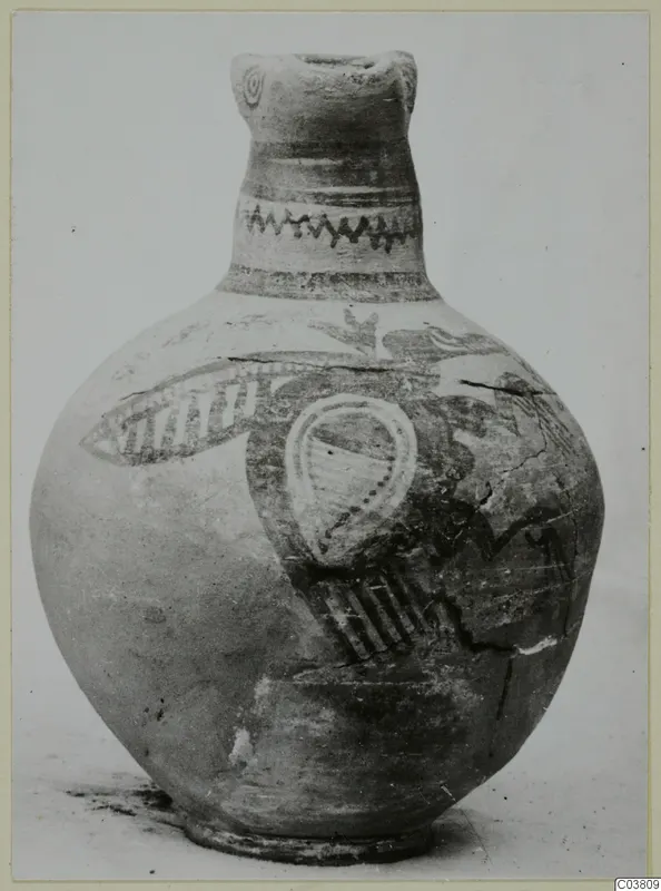 Painted jug with a tall neck, zigzag bands on the neck and large dark motifs on a pale, rounded body.