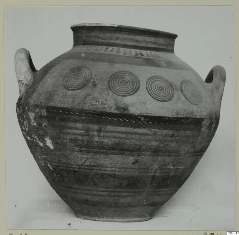Large two-handled jar with a wide mouth, dark painted bands and four concentric circles on the shoulder.