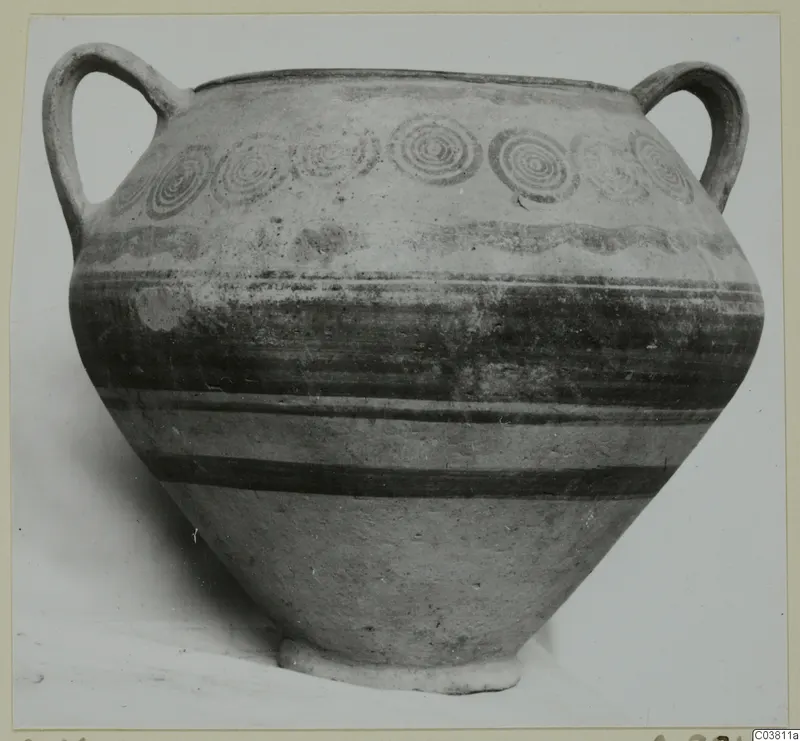 Two-handled painted pottery jar with concentric circle motifs on the shoulder and dark horizontal bands on the body.