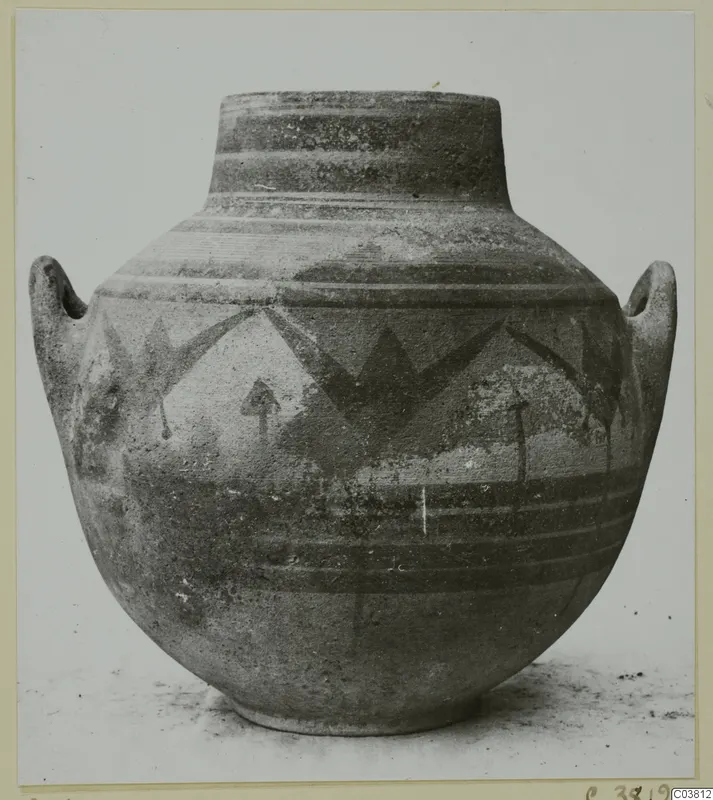 Large painted jar with two handles and a narrow neck, decorated with dark bands and angular motifs.