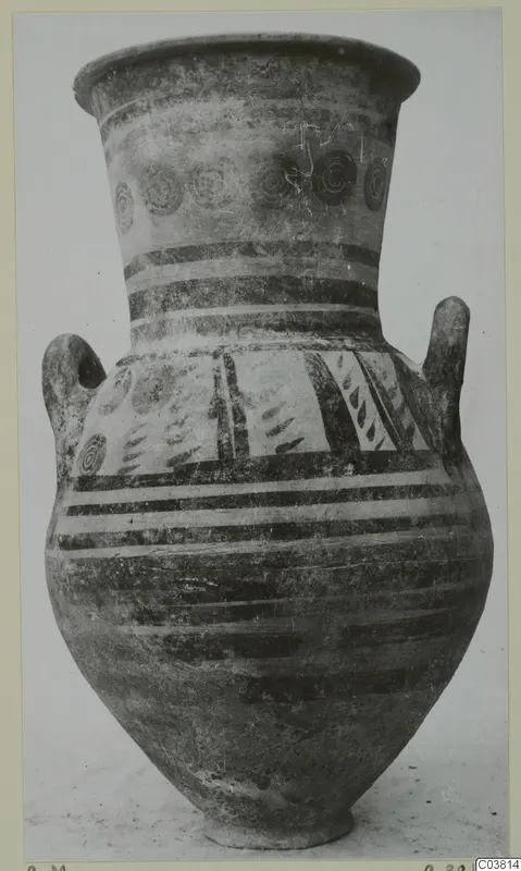 Tall two-handled painted pottery jar with a flaring neck, photographed upright against a pale background.