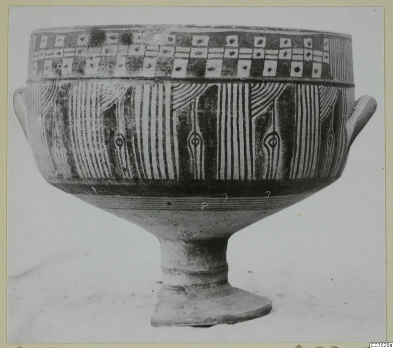 Painted pottery vessel on a high foot, with two small side handles and bands of vertical stripes and square panels
