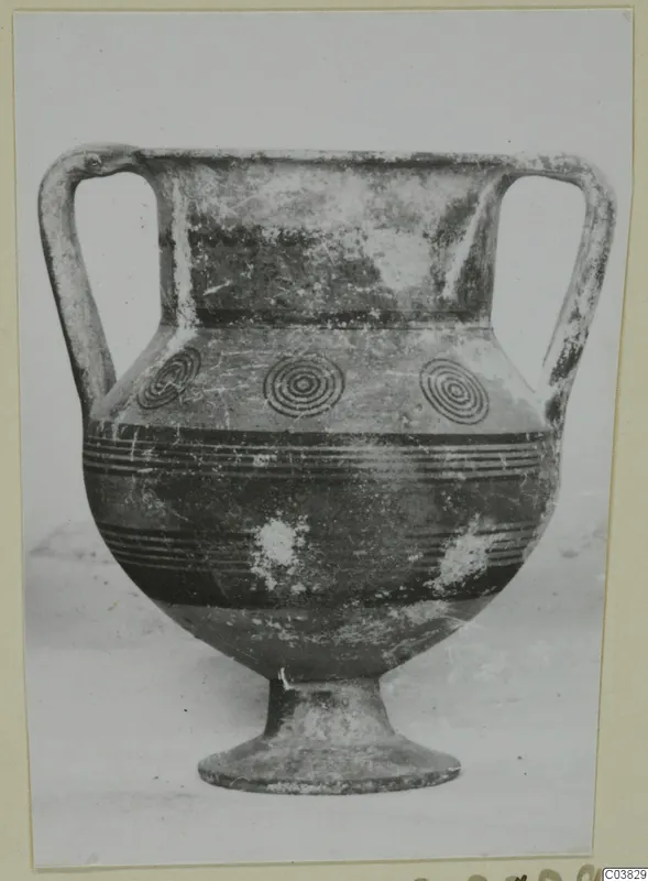 Two-handled amphora-crater with concentric circles and dark horizontal bands, on a pedestal foot.