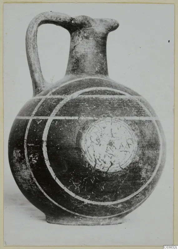 Jug with a strap handle and a globular body, its dark surface marked with pale painted bands and concentric arcs